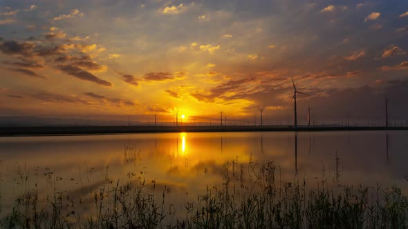 Windmills Turbines with Sunrise Reflection alt