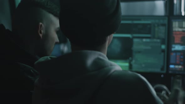 Male Hackers Copying Hacked Data alt