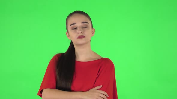 Portrait of Pretty Young Woman Is Waiting with Boredom. Green Screen alt