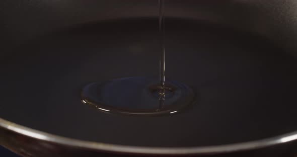 Sunflower oil is poured into a preheated frying pan