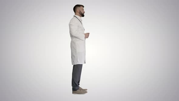 Confident Doctor Talking To Someone on Gradient Background alt