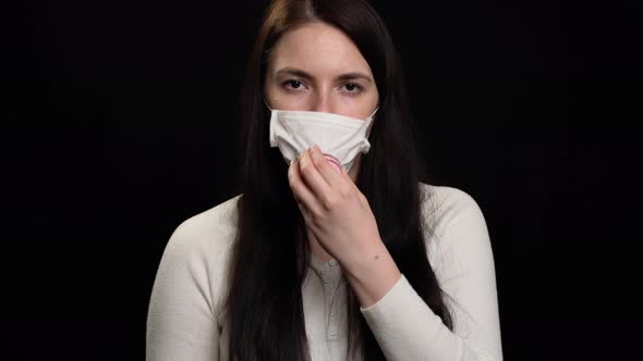 Woman with Handmade Protective Mask on Black Background alt