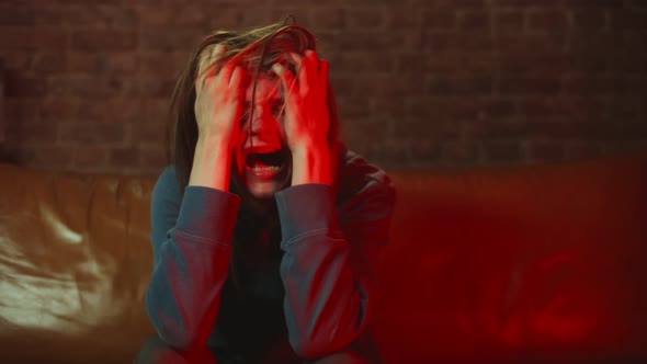 Junkie Man Sitting on Couch Having Withdrawal Symptoms alt