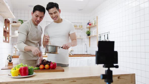 Asia gay couple blogger vlogger and online influencer recording video content on healthy food alt