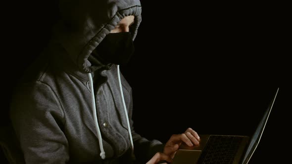 Man wearing mask while checking computer, in panic because of market crash caused by corona virus 4k alt