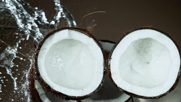 Super Slow Motion Shot of Flying Fresh Coconuts and Water Side Splash at 1000Fps. alt