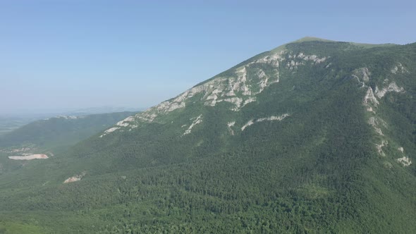 Mountain Rtanj top under green grass and forest 4K aerial video