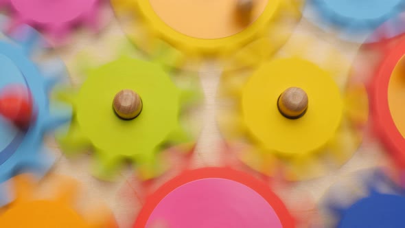 Gears and Cogs Macro in Colorful Wooden Toy. Team Work Concept. Connection Background. Business alt