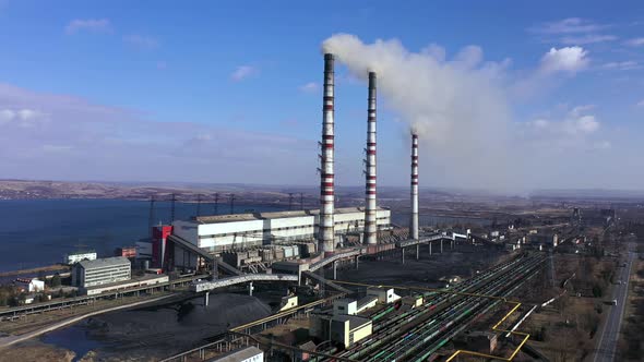Aerial View of Old Thermoelectric Plant with Big Chimneys in a Rural Landscape Near the Reservoir alt