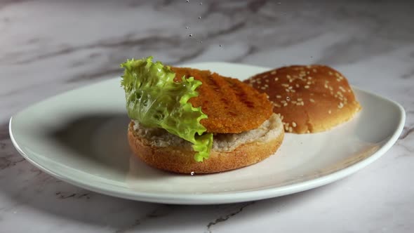 Burger Ingredients Fall on a White Plate