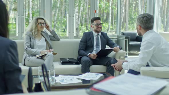 Cheerful Businesspeople Discussing Finances alt