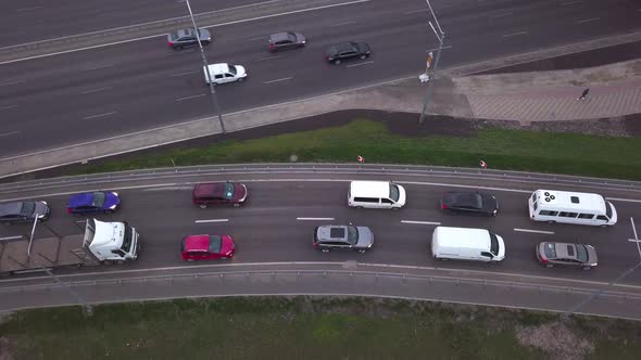 Lowangle Drone Flight Over a Massive Intersection During Early Evening Rush Hour with Cyclists