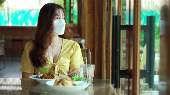 woman with a face mask in restaurant