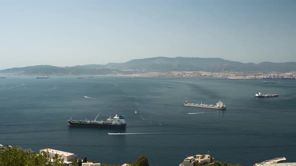 Large fishing and cargo boats in Gibraltar bay harbor, panoramic shot. alt