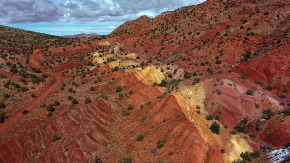 Aerial view over orange and yellow rock formations in vermillion cliffs, utah. alt