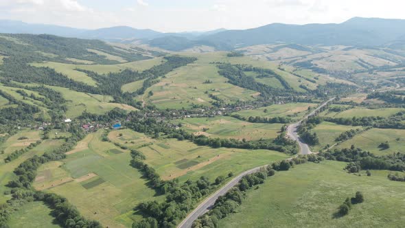 Drone filming of the Carpathian mountains in Ukraine. Cars are driving along the winding road