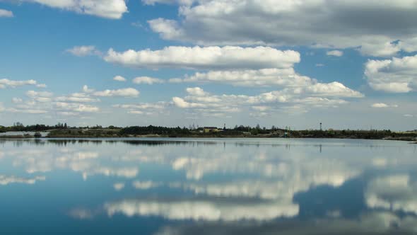Time Lapse Clouds Symetrical Reflection in Lake