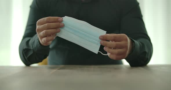 Holding A Surgical Mask In Hand alt