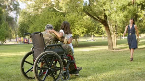 Excited Kids and Their Mom Running To Disabled Military Dad alt