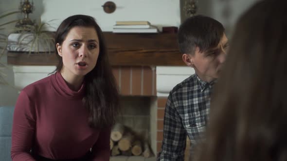 Portrait of a Young Pretty Caucasian Woman Talking Emotionally and Gesturing alt