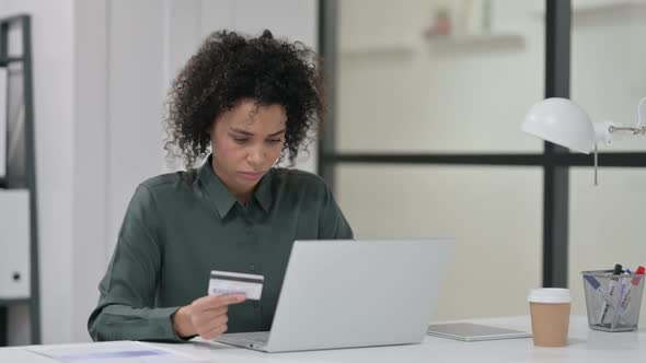 African Woman Upset By Online Payment Failure on Laptop alt
