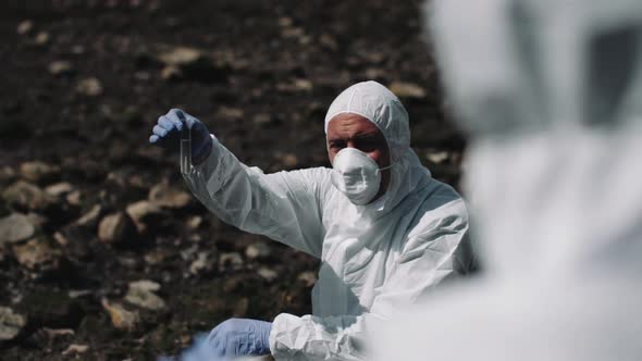 Forensic scientist examining sample at river bank