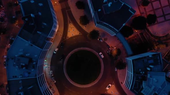 Aerial top view of cars in roundabout in lisbon city, blue and orange colors alt