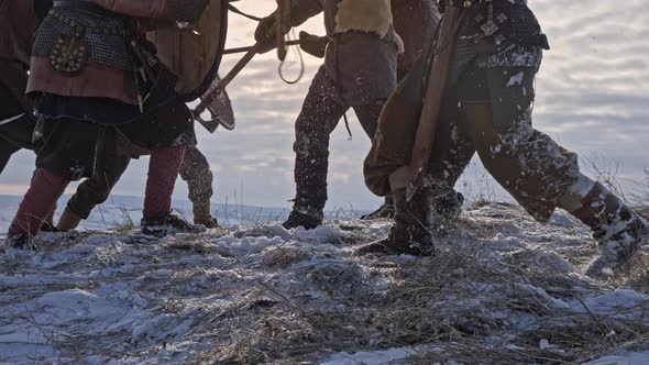 Legs of Viking Warriors, During Attack at Winter Time. Medieval Reenactment. alt