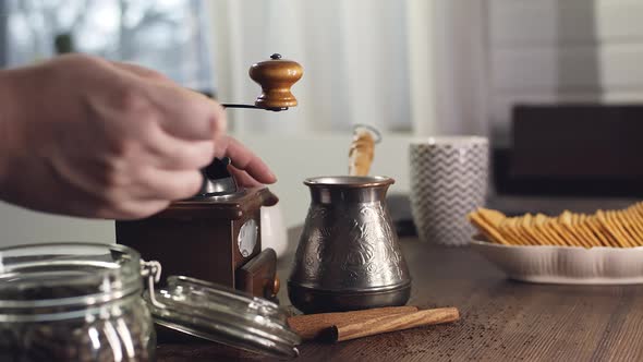 The Process of Grinding Coffee Beans in a Retro Mill alt