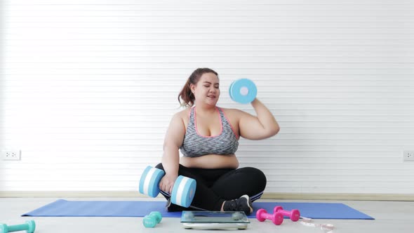 Asian Overweight young woman in sportswear exercising to lose weight at home