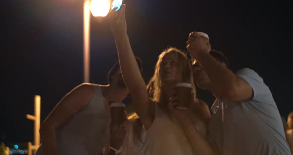 Friends with coffee making selfie and laughing at photo alt