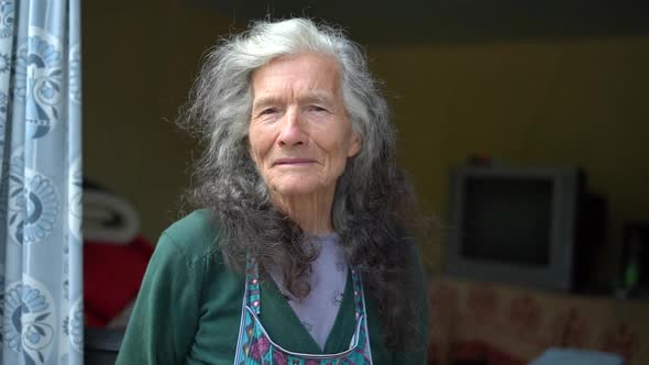 Old Grandmother a Country Woman Near Her House alt