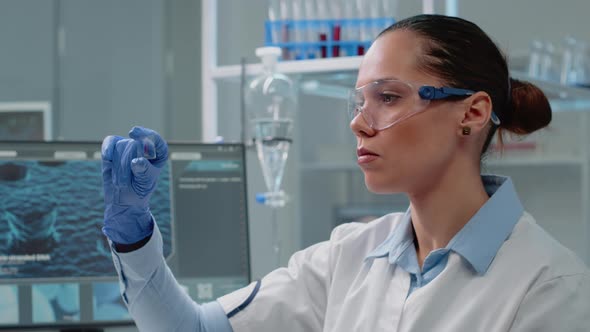 Chemistry Specialist Analyzing Blood Sample on Glass alt