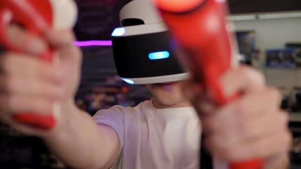 Closeup of a Teenage Boy Playing a VR Game She Uses a Virtual Reality Headset alt