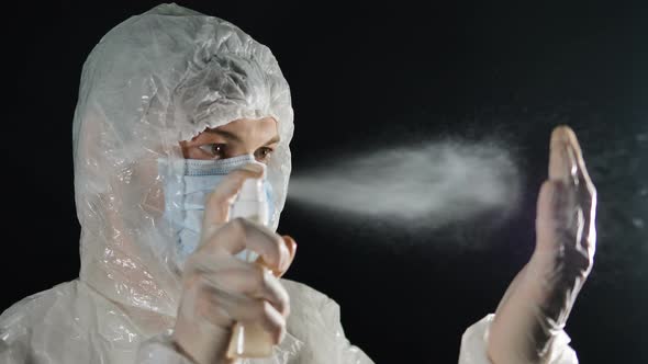 Doctor Clicks on Antiseptic and Handles Gloves, Splashes Fly, Protection and Treatment From alt