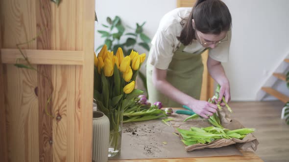 Professional Florist Cuts the Stems of Fresh Flowers