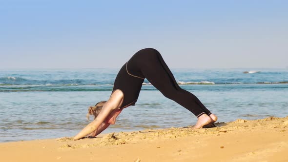 Fair Haired Girl in Black Tracksuit Changes Yoga Poses alt