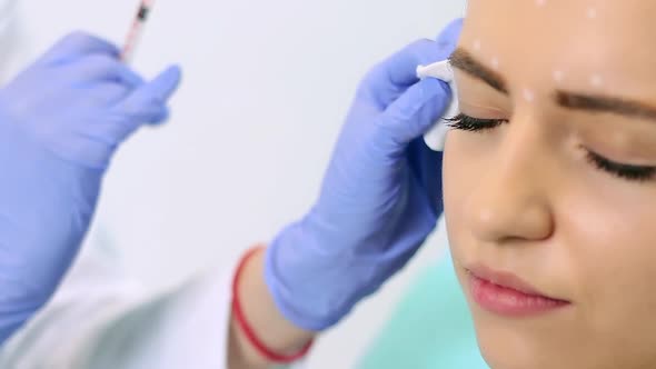 The Beautician Makes a Treatment Procedure to the Patient