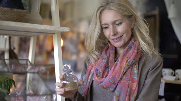 Mature woman choosing glass candles
