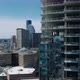 Slide and Pan Footage of Construction of New High Rise Buildings with Glossy Glass Facade