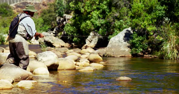 Man fly fishing in river alt