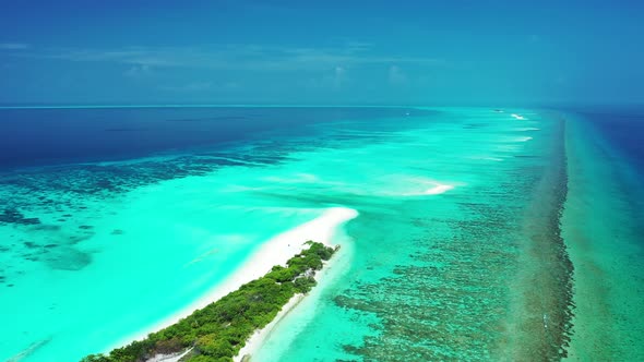Luxury above tourism shot of a white sand paradise beach and turquoise sea background in 4K alt