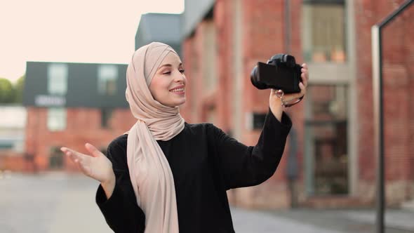 Happy and Excited Arabic Girl Traveler Wear Black Clothes with Hijab Waving to Internet Audience