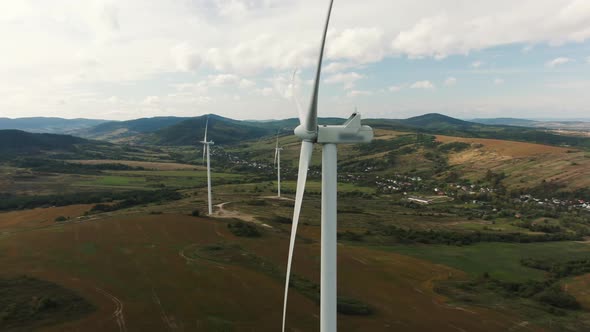 Camera Flight Over Landscape with Power Plant. Aerial View To Wind Turbine. Sustainable Electricity alt