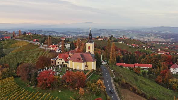 Aerial View of Austrian Vilage Kitzeck Im Sausal on Vineyard. Shoot of Church on the Top of Grape