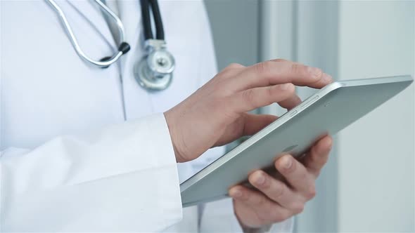 Doctor In Hospital Using Digital Tablet Computer