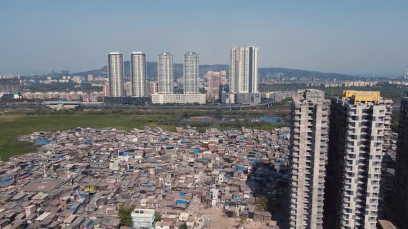 Aerial view of both high-rise buildings and slums in Mumbai city, Maharashtra.