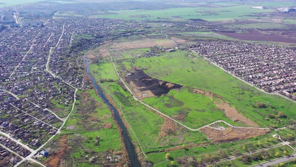 A field after a fire near the river. Aerial view.