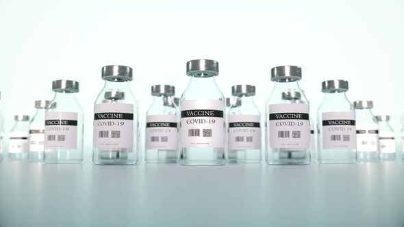 Coronavirus Vaccine in Ampoules Closeup on a Laboratory Table Blue Background alt