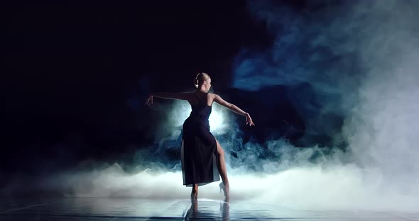 An Attractive Dancer Raises Her Hands Up